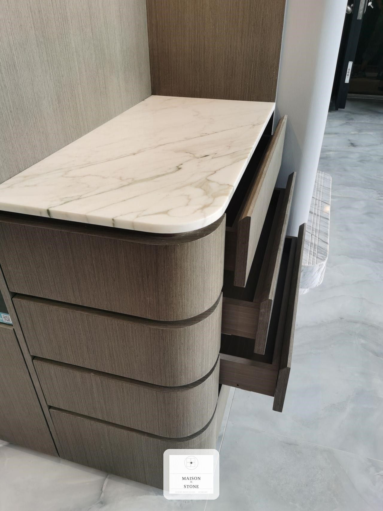 Close-up detail of custom curved cabinet joinery and marble countertop, luxury kitchen renovation Gauteng