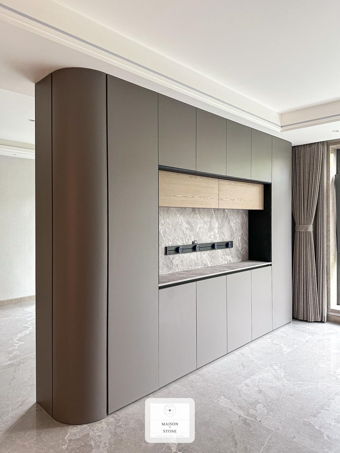 Curved living room cabinetry feature wall with marble backsplash, custom home renovation Gauteng